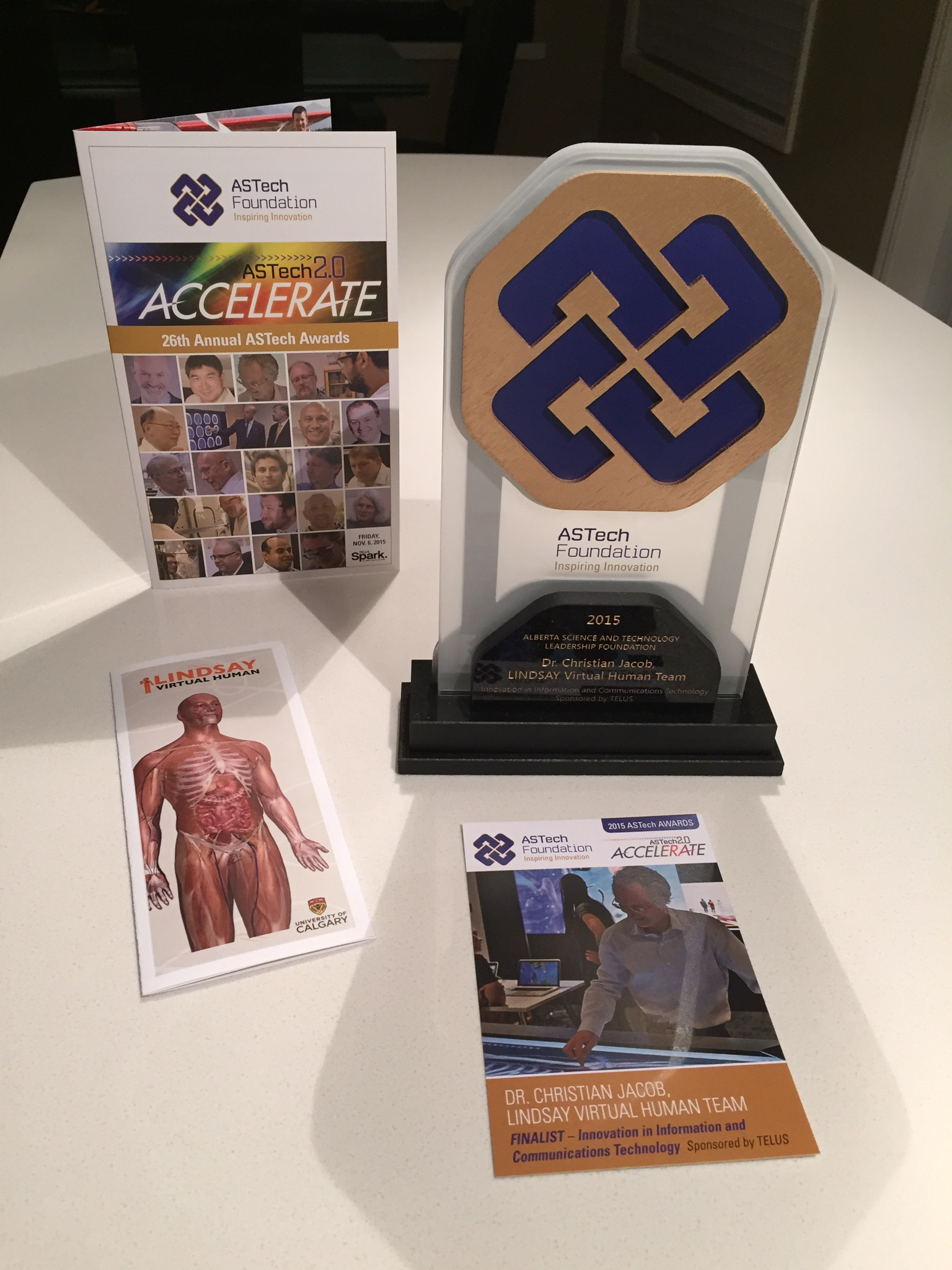 ASTech brochure, trophy, and plaque notes with LINDSAY brochure